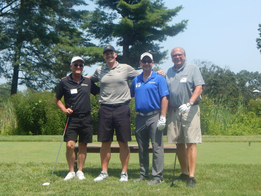 Members of the NDIA Delaware Valley Chapter pose on the golf green.